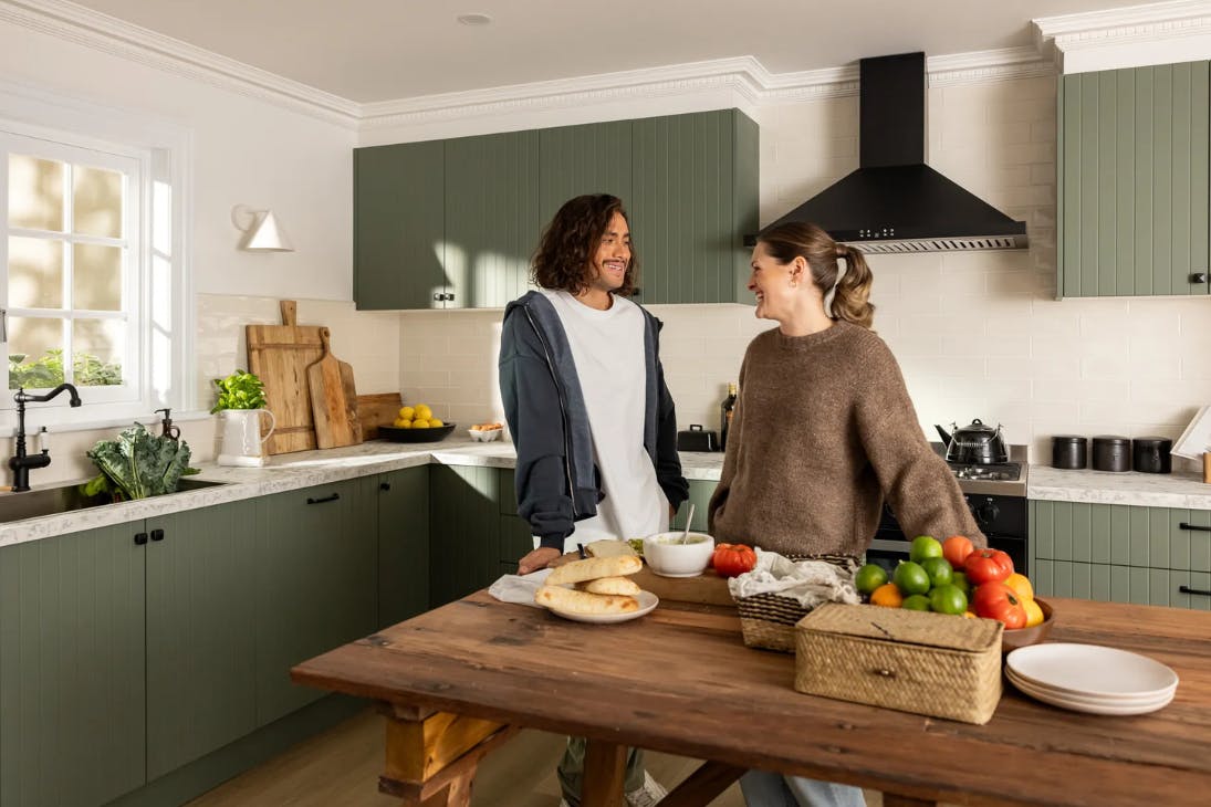 Two people standing in kitchen